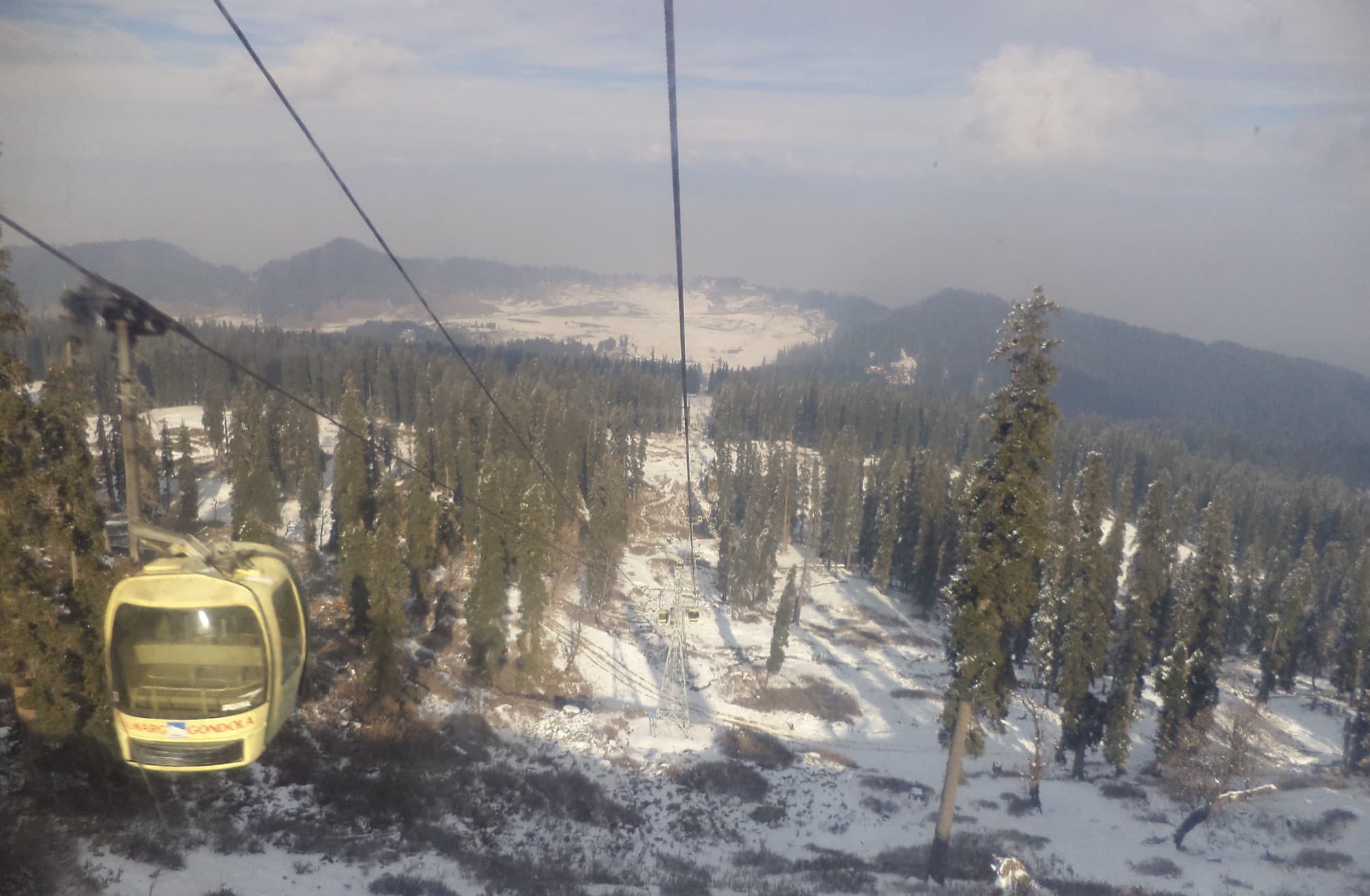Riding the Gulmarg gondola over snow-dusted pines